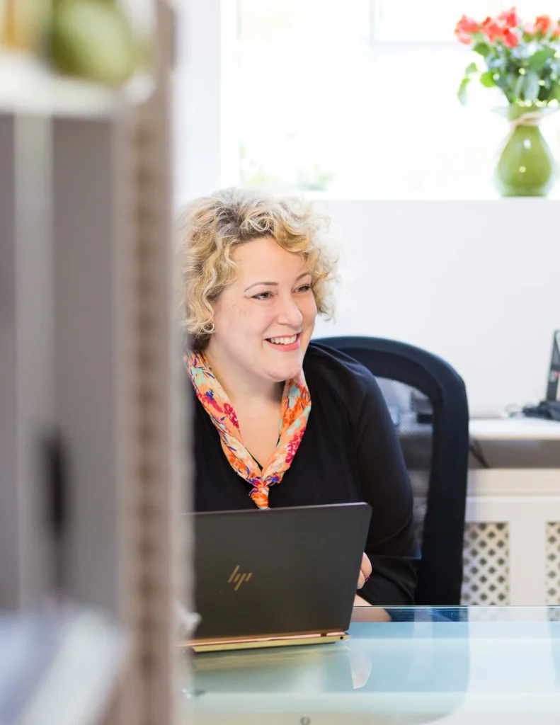 Shuna Hammocks at her desk with a laptop, ready for a video consultation